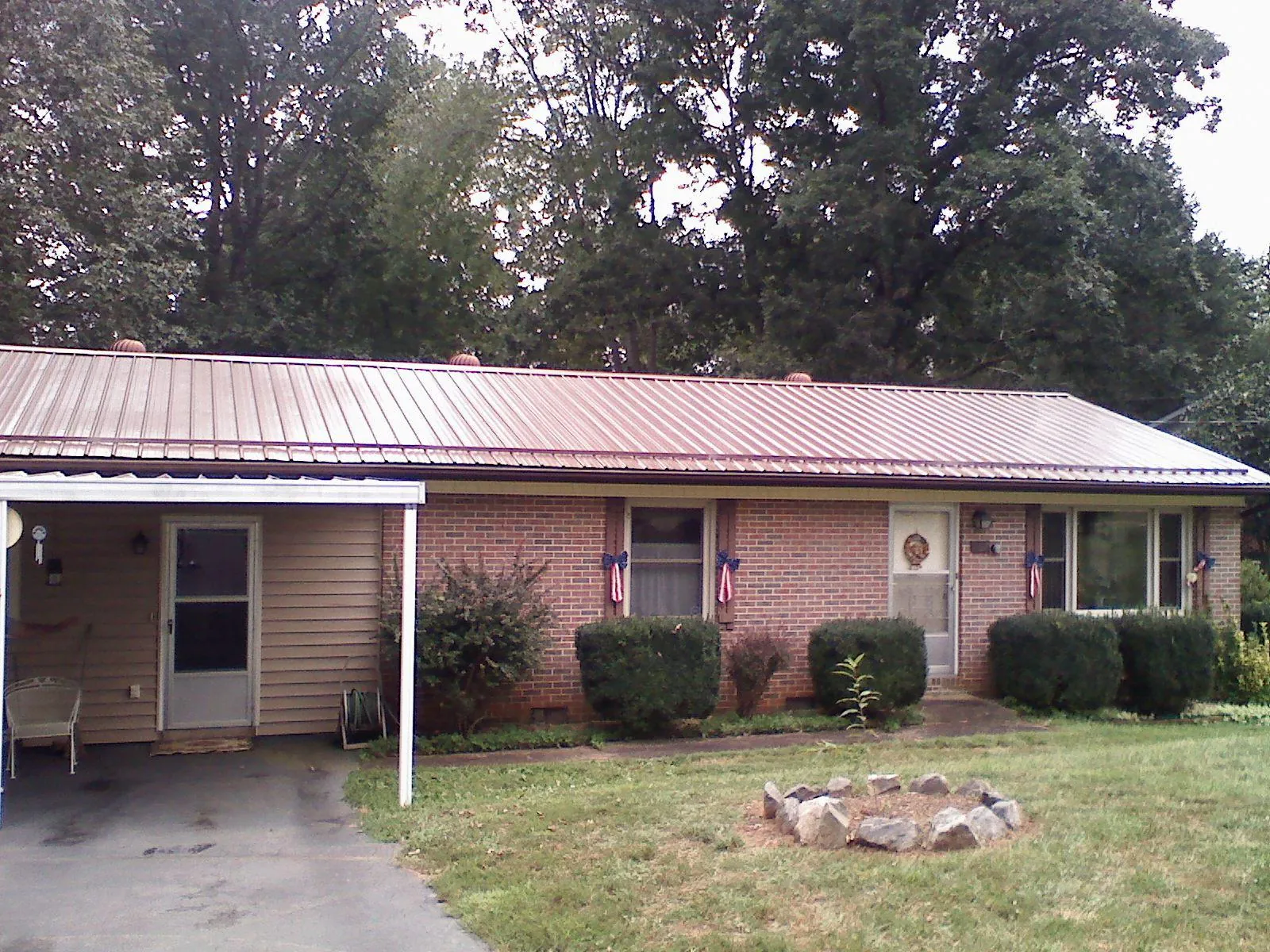 Bronze metal roof and carport on a brick ranch home — Roof Repair work by our crew in West Middlesex