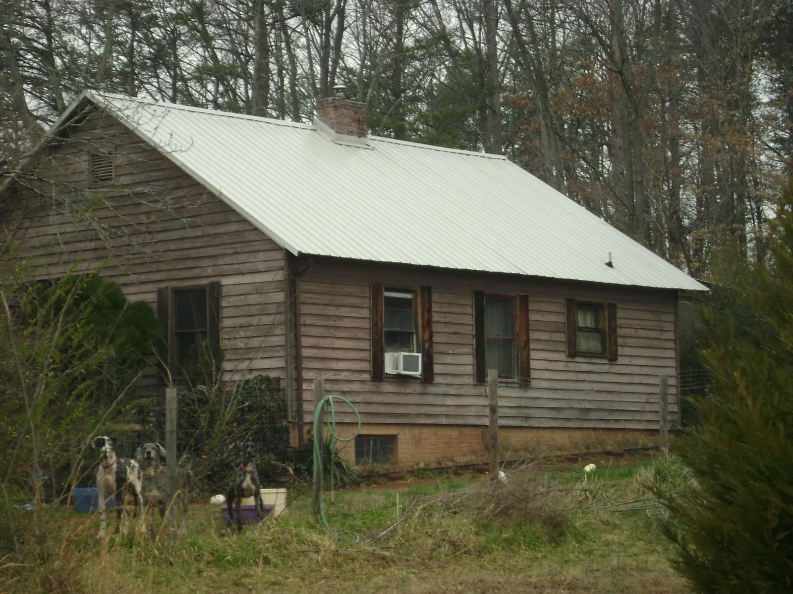 White metal roof on an old wood sided farmhouse, from a Metal Roof Installation job in West Middlesex